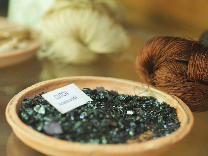 green dye crystals in wooden bowl